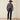 Ariat M5 Slim Stretch Coltrane Stackable Straight Leg Jean in Nightingale — straight leg over a boot. Back view.