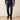 Ariat FR M7 Slim DuraStretch Straight Leg Jean in Shale — slim straight leg over work boots. Front view on model.