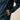 Ariat Caldwell Logo 1/4 Zip Sweater in Dark Teal Southwest — zippered hand pocket and sleeve logo. Detail view.