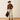 Ariat M4 Relaxed Grizzly Boot Cut Jean in Cedar Brown — boot cut over cowboy boots. Full-length view on model.