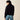 Ariat Butler Pullover in Black — wrapped collar and ribbed hem. Back view on model.