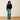 Ariat Butler Pullover in Black — fleece pullover with jeans. Full-length view on model.