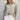 Eesome ruffle hem button down in Dry Herb — gathered ruffle hem, chest pocket, tab cuffs. Front on-model.