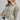 Eesome ruffle hem button down in Dry Herb — tab button cuff and drop shoulder. Side on-model.