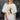Eesome Weenies and Martinis graphic tee in Bone — dachshund with a martini on a yellow stripe panel. Front on-model.