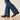 Ariat Lilla Boot Cut Jean in Ashland — boot cut hem over boots. Detail view.