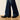 Ariat Perfect Rise Davina Trouser Jean in Irvine — wide trouser hem over boots. Detail view.