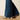 Ariat Petra Flipside Wide Leg Jean in Montrose — raw hem over boots. Detail view.