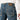 Circle A Western and Work Ariat Men's M4 low rise boot cut jeans in blue denim with contrast stitching and leather logo patch.