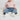 Circle A Western and Work baby girl wearing Wrangler trouser jeans with a light pink sweater on a white rug