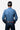 Circle A Western and Work men's blue long sleeve snap shirt with western yoke detail. Model wears jeans and a baseball cap.