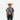 Boy wearing a Circle A Western and Work blue multi-print short sleeve polo shirt, cowboy hat, and dark denim jeans.