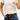 Circle A Western and Work cream cotton pocket tee with raised gold RQ embroidery worn by a woman with denim jeans