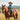 Circle A Western and Work desert blue polo shirt worn by a young boy in a cowboy hat riding a horse in a field