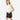 Circle A Western and Work girls wearing distressed black denim shorts with a white ruffled sleeveless top