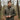 Man wearing a Circle A Western and Work duck down vest in Original Bottomland camo pattern in a forest setting.