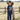 Young boy wearing a Circle A Western and Work navy short sleeve graphic tee and cowboy hat in a rural field.