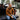 Circle A Western and Work rust quarter-zip hoodie with camo hood lining worn by a man sitting on a truck tailgate