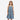 A young girl wearing a Circle A Western and Work Wrangler sleeveless blue denim swing dress with white floral boot print.