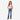 Young girl wearing Circle A Western and Work Wrangler boot cut jeans and a pink t-shirt with brown western boots
