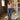 Circle A Western woman wearing a peach mineral-washed cotton crop tee with "Play Something Country" graphic, blue jeans, and cowboy boots.