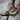 Danner MTN45 Mid GTX Hiking Boot in Bone Brown — lacing up on the trail. Lifestyle view on model.